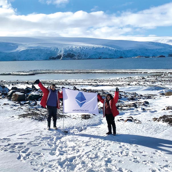 Aditthya Ramakrishnan and Maanasa holding the Ethereum flag in Antarctica