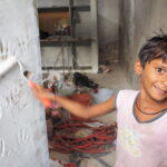 Kids add the finishing touches to the Anganwadi