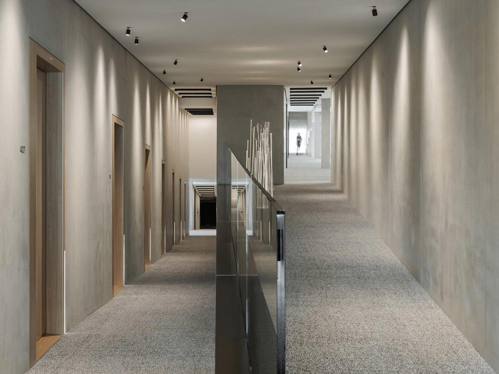An interior passageway follows the zigzagging structure of the building and links the rooms