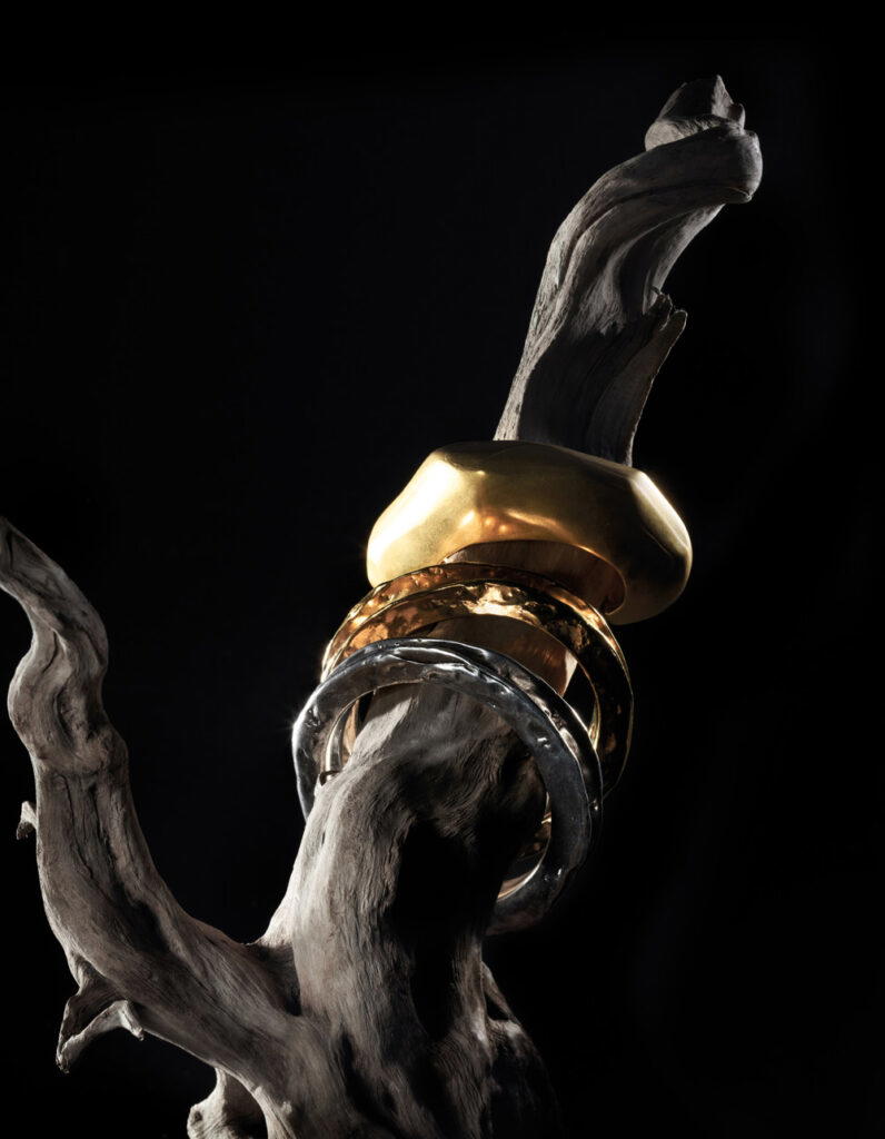 Metal cuff, metal bangle in aged gold and metal bangle in oxidised silver, all from Saint Laurent