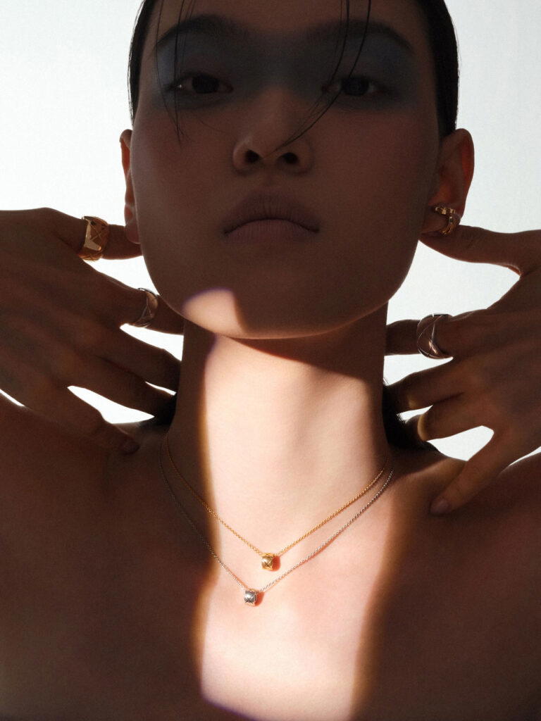 Eternal N°5 earring in beige gold with diamonds, Coco Crush rings in beige and white gold, and Coco Crush necklaces in beige and white gold, all from Chanel