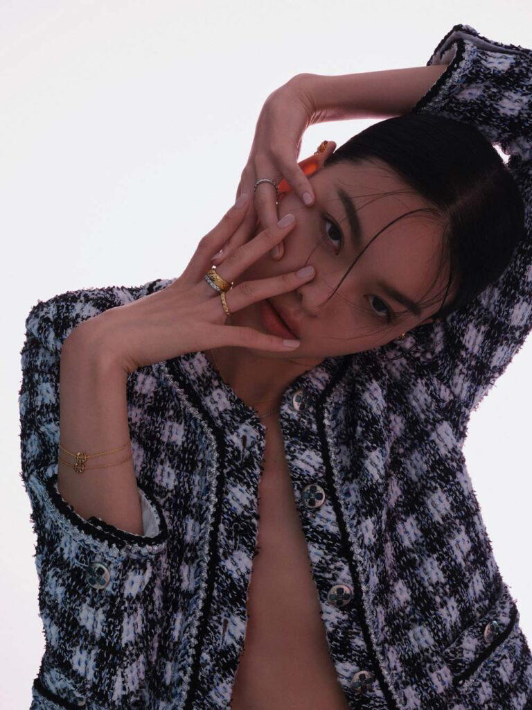 Fantasy tweed jacket, Coco Crush earrings in white and yellow gold, Coco Crush rings in white and yellow gold with diamonds, and Coco Crush bracelets in yellow and beige gold, all from Chanel