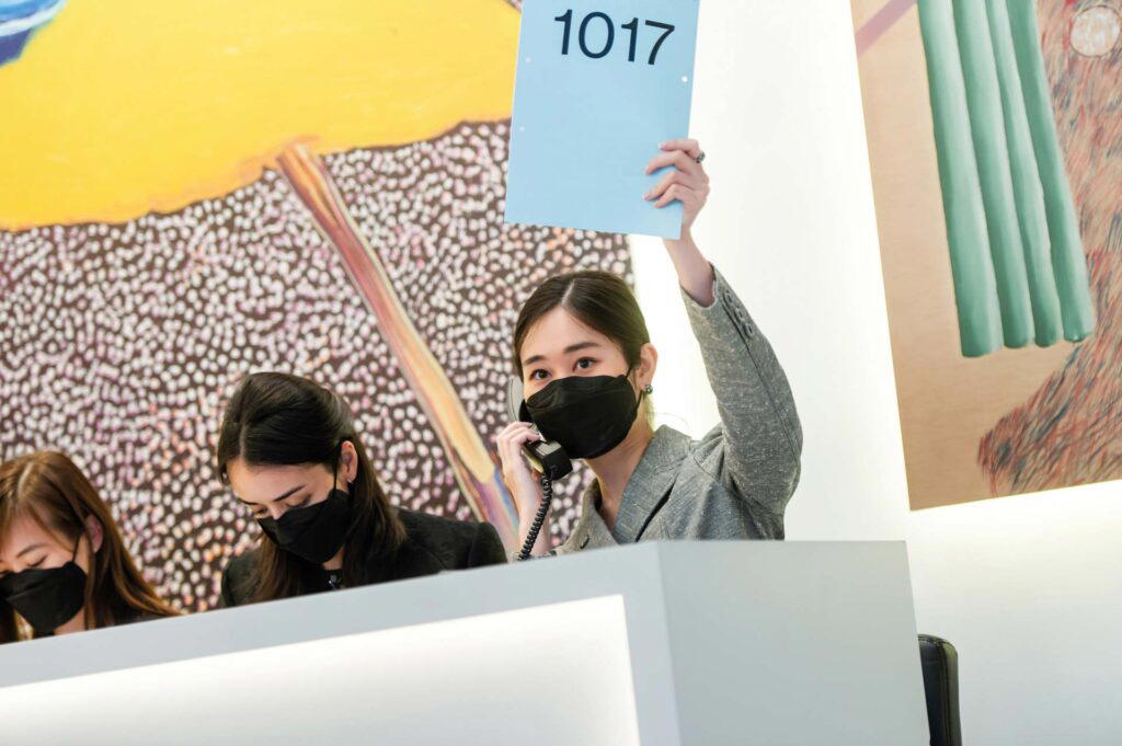 Danielle So mans the phone during an auction