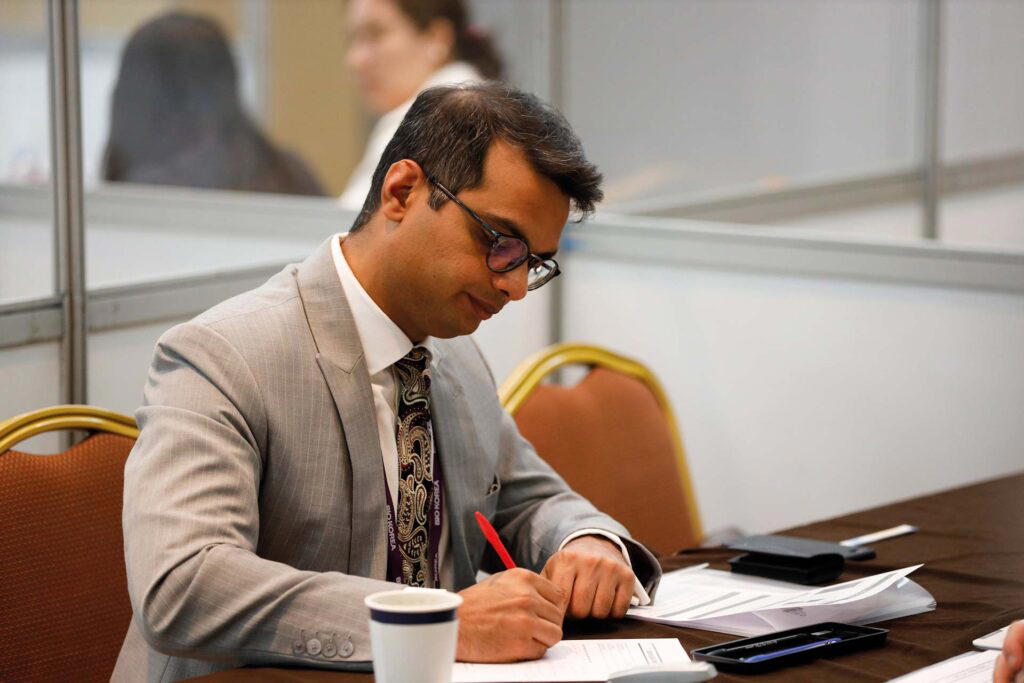 Vishal Doshi signing an agreement