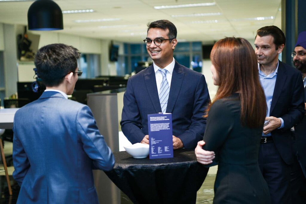 Vishal Doshi laughing with a group of people