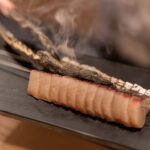 Spanish mackerel being grilled with charcoal