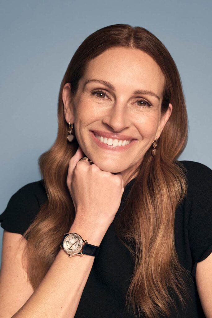 Julia Roberts wearing Chopard Happy Sport 33mm in rose gold and stainless steel, and Happy Hearts earrings in rose gold with mother of pearl