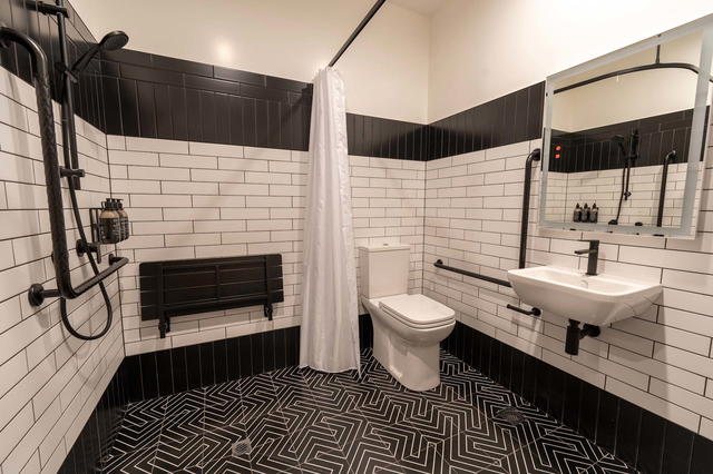 The black-and-white theme permeates across all of the hotel's bathrooms
