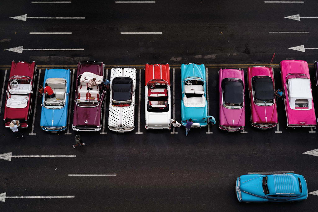 Proud owners of highly sought-after vintage American cars strategically park outside of the best hotels. They constantly jockey for people who want to cruise down the Malecón in Havana (Credit: Lionel Leo)