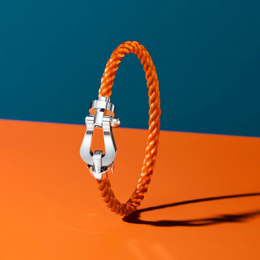 Force 10 capsule collection buckle in white gold with a terracotta-coloured braided bracelet (Credit: Fred)