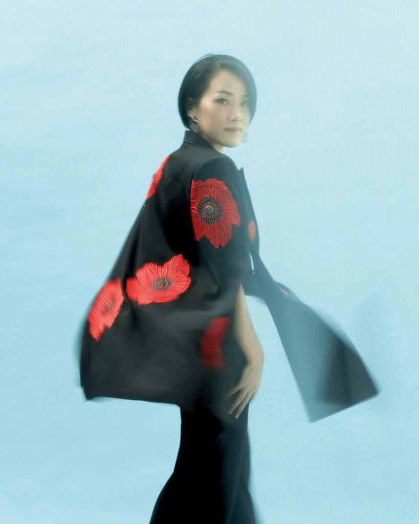 Deborah Widjaja is dressed in her own cape and trousers