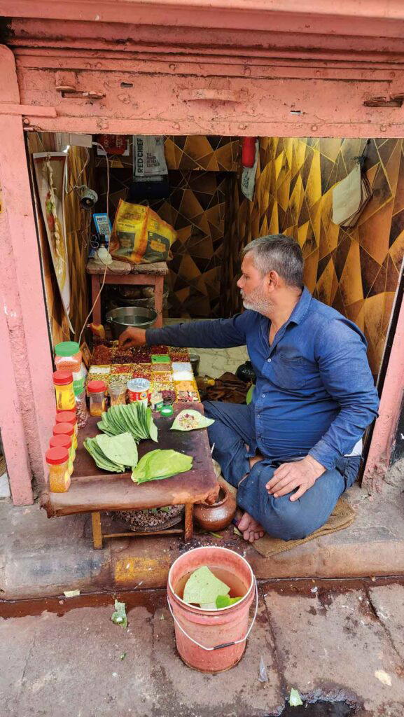 A street vendor selling paan, a snack with betel nut and lime