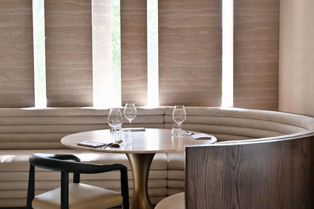 The interior of Restaurant Fiz is a palette of white hues with wooden accoutrements