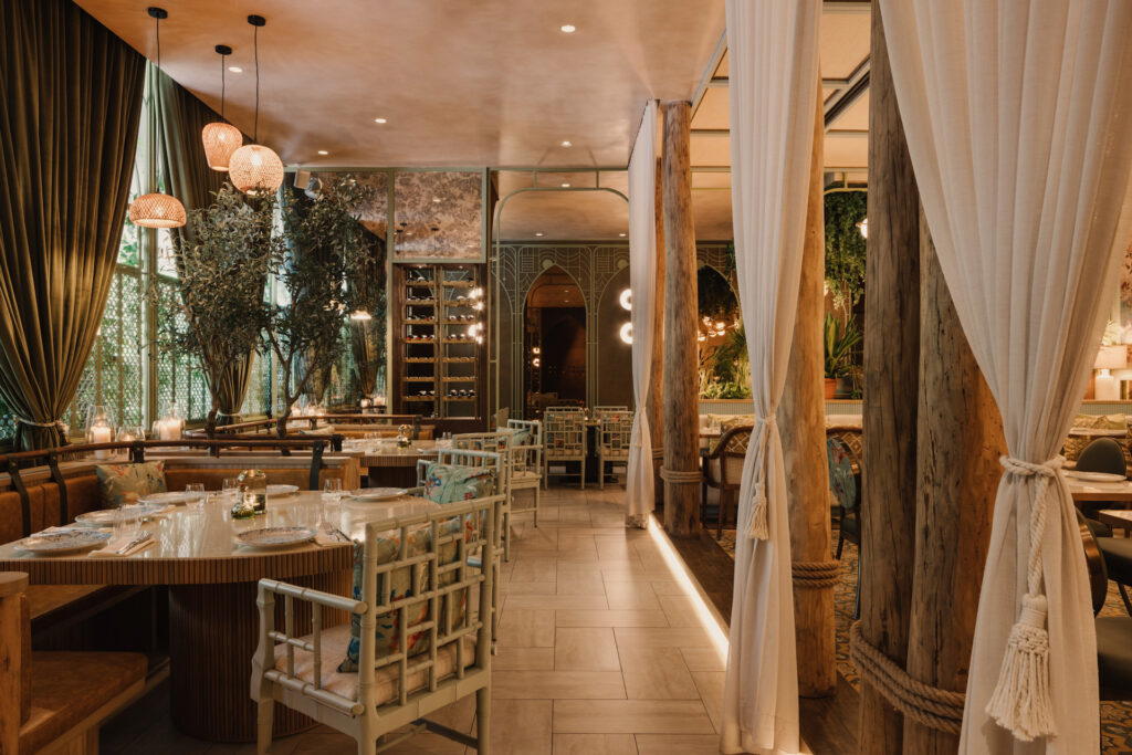 Rattan furniture, elegant arches, and mosaics add a touch of glamour