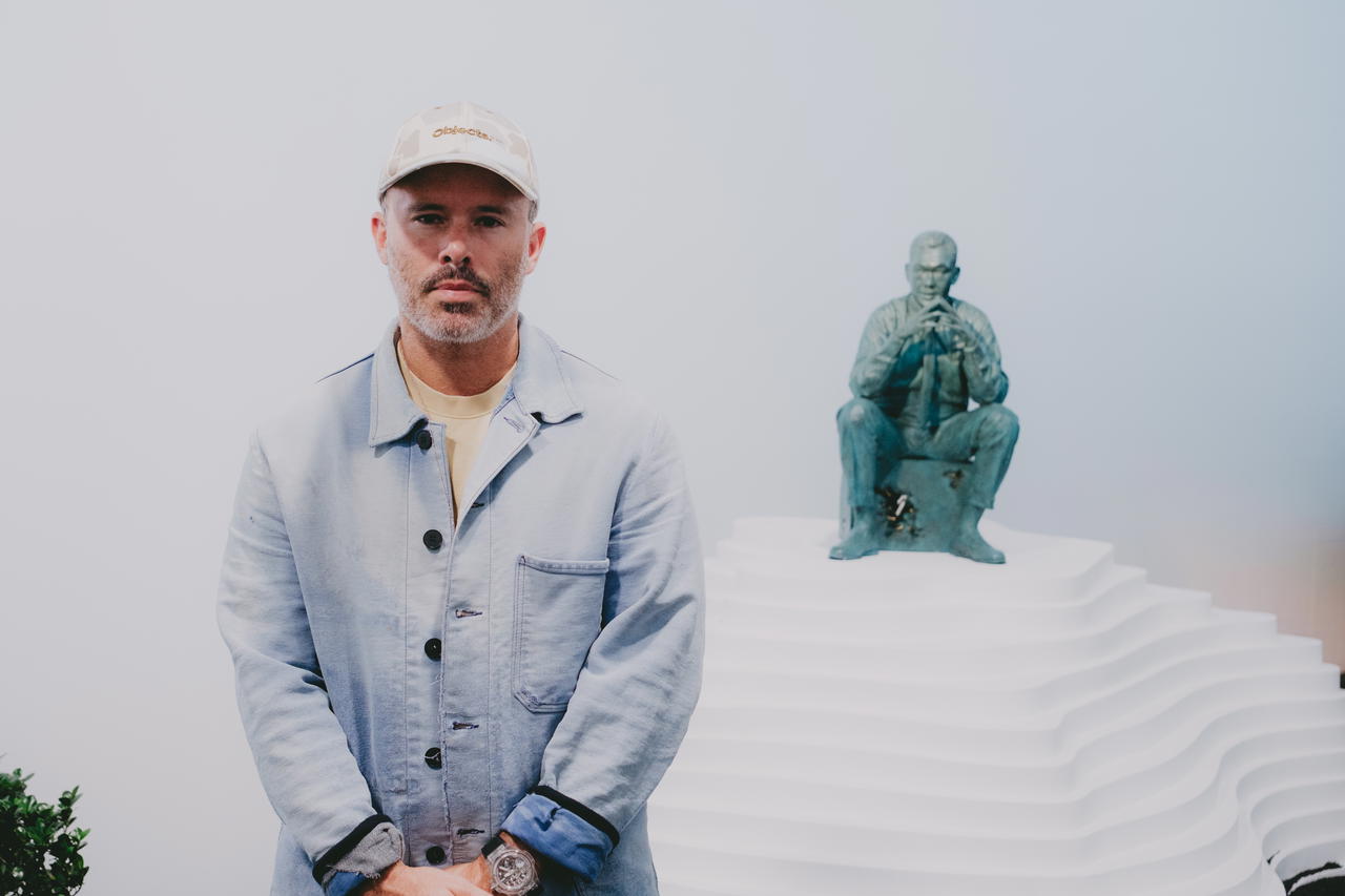 Daniel Arsham poses with his eroded bronze Lee Kuan Yew sculpture