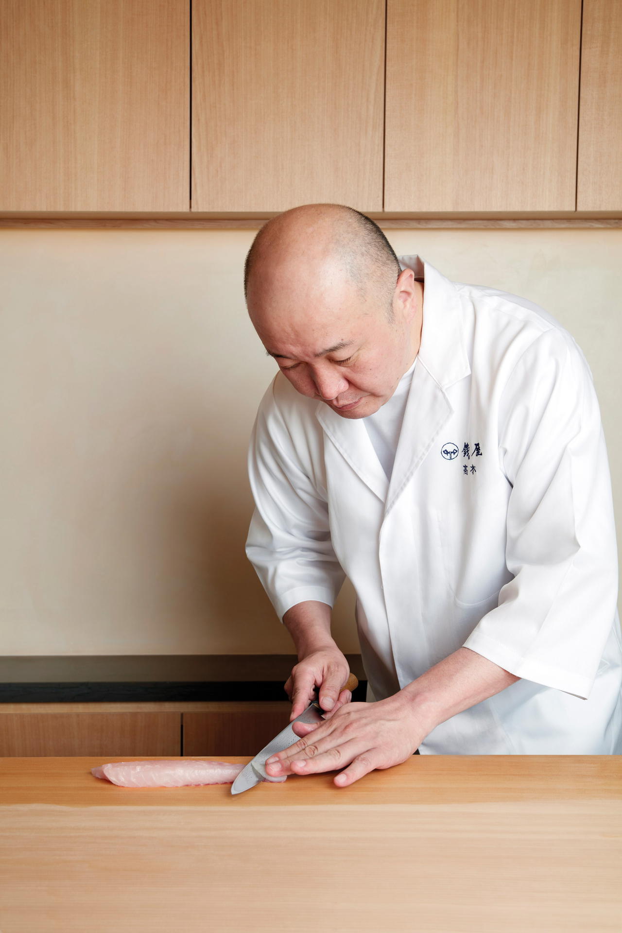 Takagi skillfully prepares the hamo (conger eel)