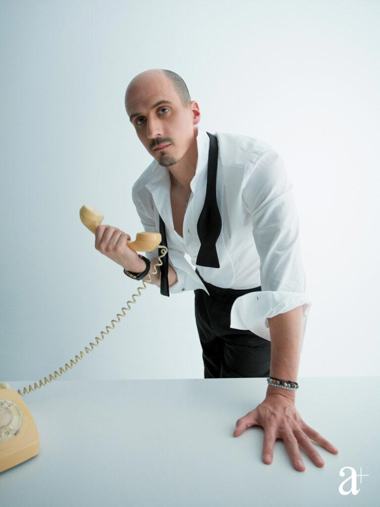 Alexandre Mille holds a rotary phone