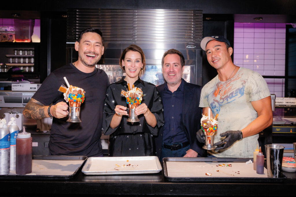 Celebrating with actors Paul Foster and Allan Wu at the fifth anniversary party