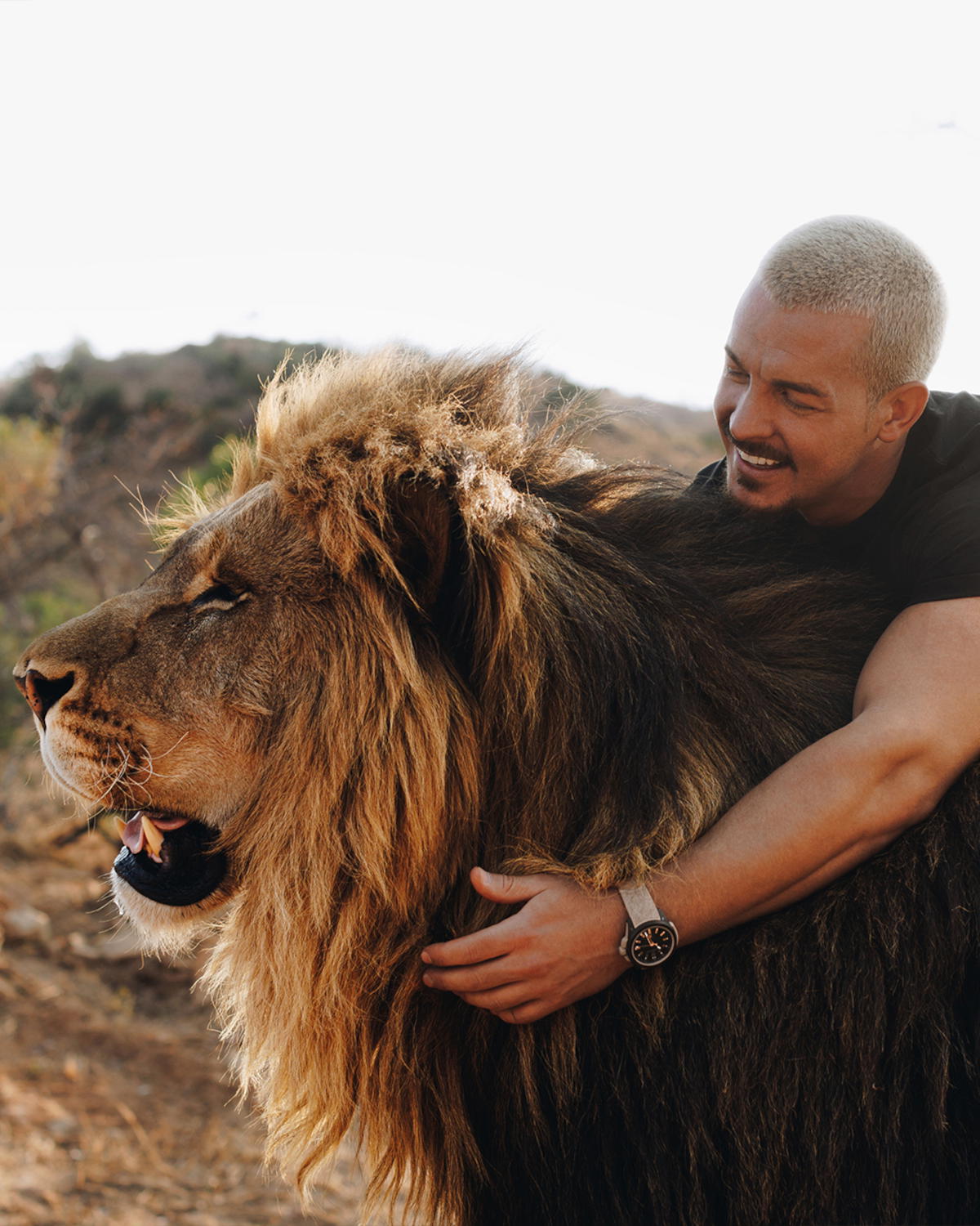 Dean Schneider with Dexter, a six-year-old lion that was his first rescue (Credit: Norqain)
