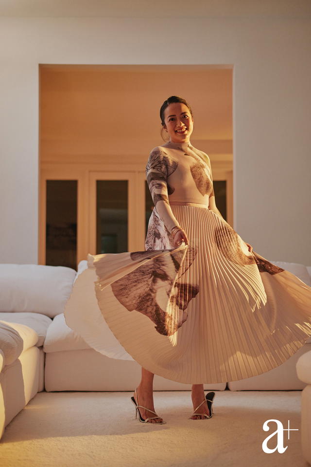 Elaine is wearing a top and skirt, from Wild Cosmos and heels, from Schutz