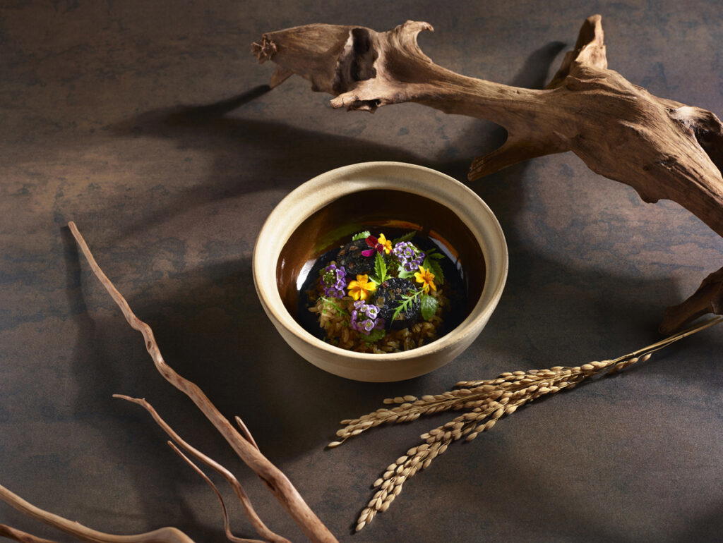 Squid sausage claypot rice with squid ink egg sauce and aromatic herbs by chef Boo Seng