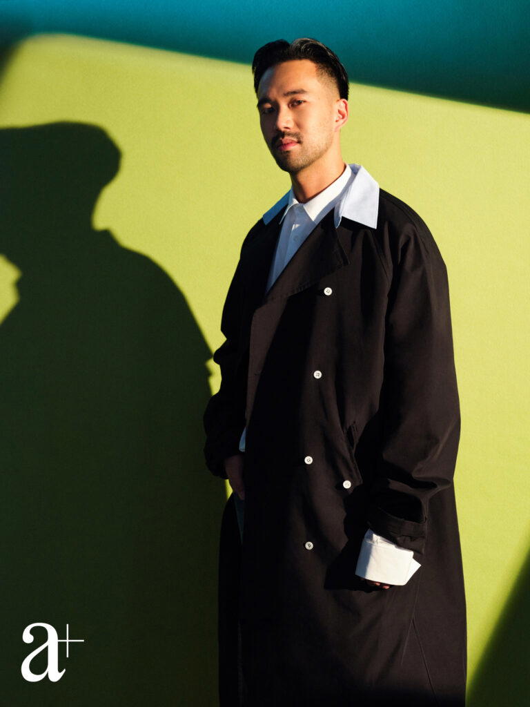 Goh is wearing a cotton shirt and nylon coat with detachable collar, from Prada