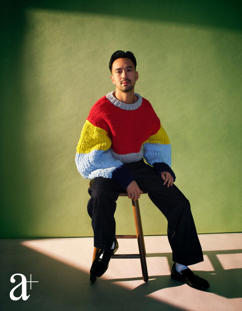 Goh is wearing a wool jumper and denim jeans from Loewe, and calfskin loafers from Prada