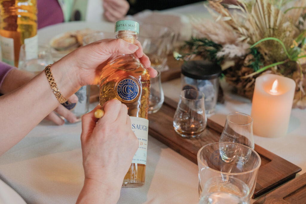 Dr Rachel Barrie signs a bottle of Glenglassaugh Sandend