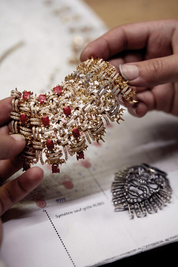 A jeweller checks and adjusts the articulations on the Tweed Royal necklace before setting the rubies