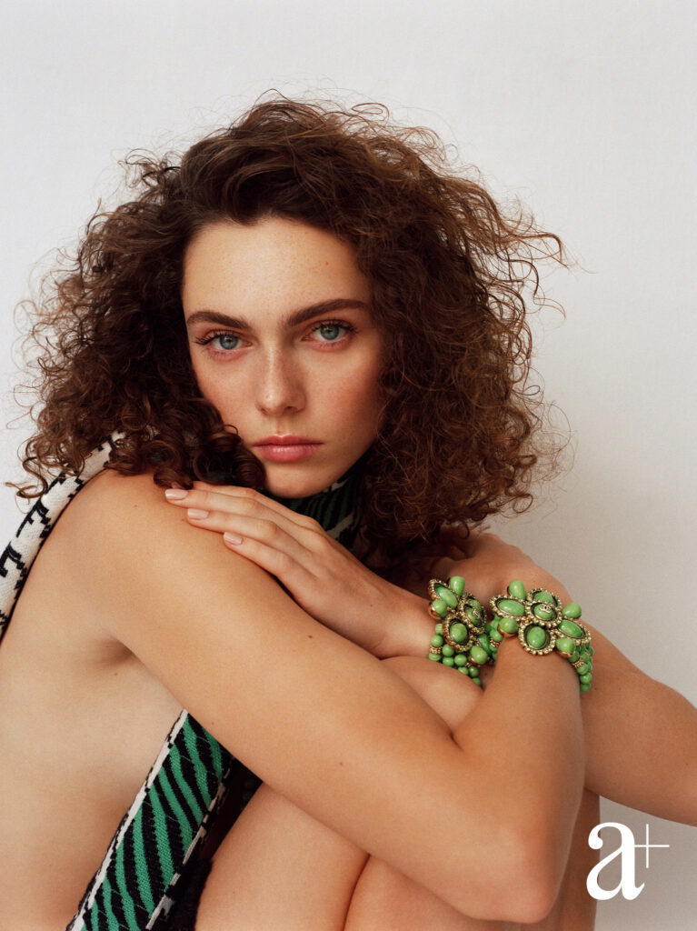 Metal bracelets with glass bead and rhinestones and cashmere blend scarf, all from Chanel