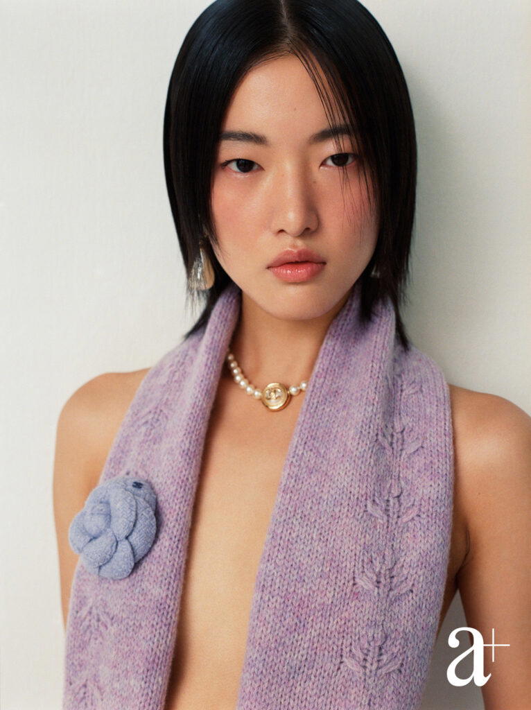 Wool scarf, metal necklace with glass beads and resin, all from Chanel