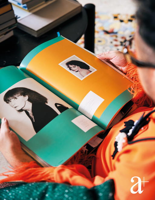 Ryan Su flips through one of his art books containing Andy Warhol's Polaroid pictures