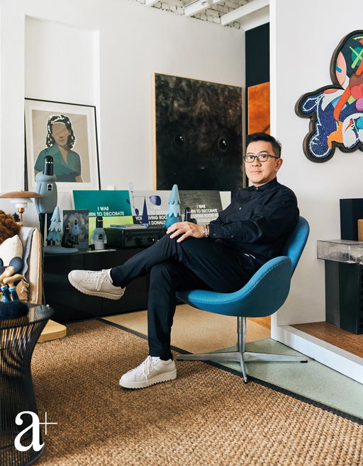 Art collector, Terence Chan, sitting on his chair in the office