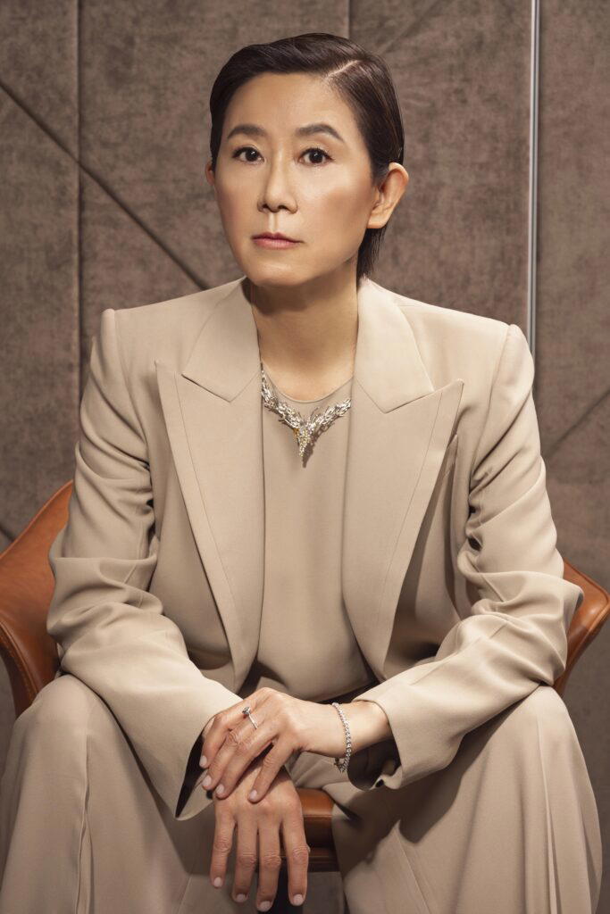 Ip wears a necklace in white gold with diamonds and sapphires, Ceylon Bay bracelet in white gold and diamonds, and a Deco Centennial Twenties Tassel Ring in white gold with diamonds (Credit: UltraLuxe)