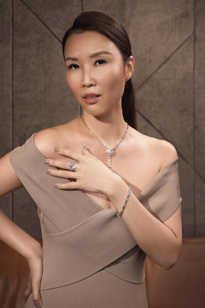 Leong wears the Deco Centennial Luminaire Lariat necklace in white gold with diamonds, High Street bracelet in white gold with diamonds, the Deco Centennial Twenties Tassel ring, and two Deco Centennial Twenties Tassel convertible ring jackets (Credit: UltraLuxe)