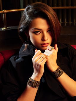 Première Cuff Watch in steel coated with yellow gold, Comète Chevron ring in white gold with diamonds, and Coco Crush ring in beige gold with diamonds; silk faille trench coat, all from Chanel