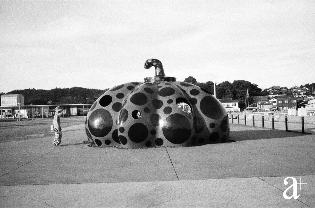 Yayoi Kusama’s red ‘Pumpkin’ greets visitors as they arrive at Naoshima’s Muranoura port, As the artist describes it, “a red sunbeam searched the outer reaches of the universe only to metamorphose into a red pumpkin in the sea off Naoshima”