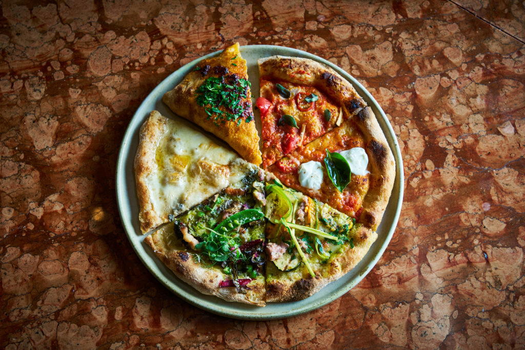 Guests enjoy eight slices of pizza, as part of the omakase-style pizza degustation menu