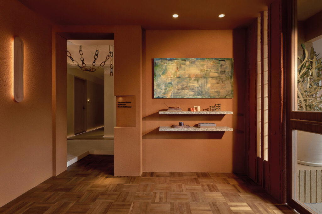 The inviting reception and retail space, showcasing a curated selection of wellness and body care essentials, including hair and body mists, candles, and incense sticks