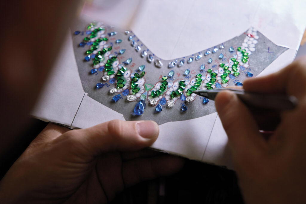 The gemstones are arranged in a style inspired by mountainous slopes