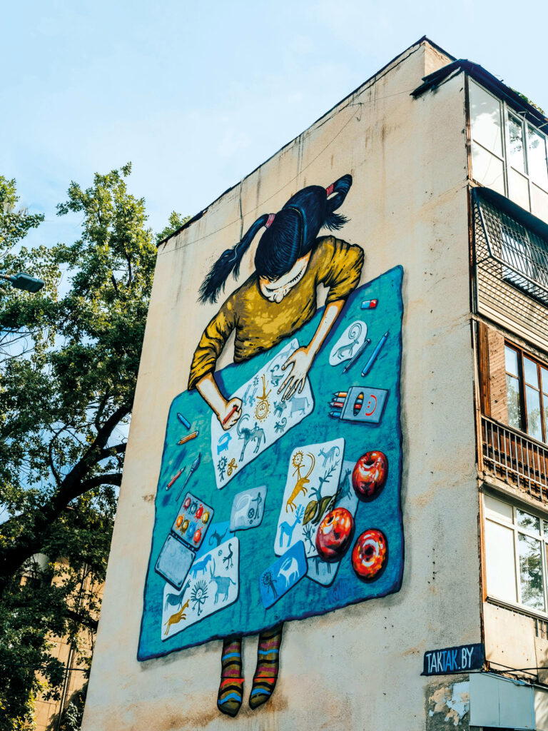 A giant mural enlivens a wall in Tulebaev Street