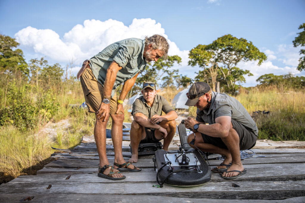 Boyes, Neef, and researcher Johan van Der Westhuizen inspecting the acoustic doppler current profiler before placing it in the Cassai River to measure the currents