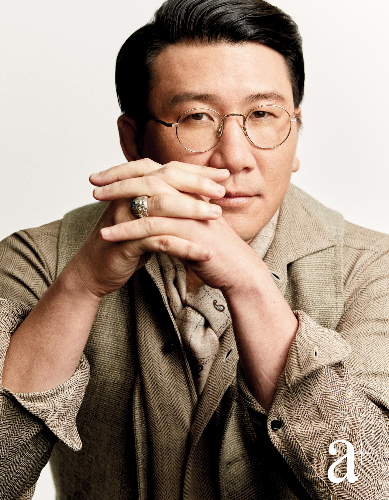 Linen shirt with matching vest, and silk printed scarf, all from Loro Piana. West Point class ring is Yu's own (Credit: Joel Low. )