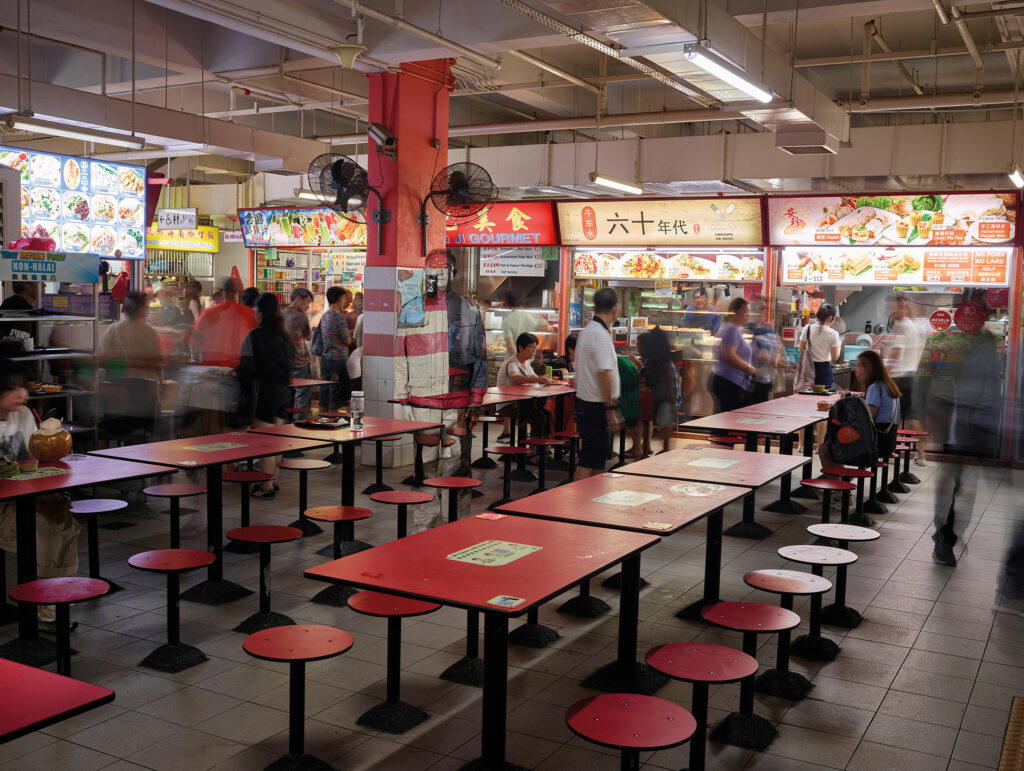The visual artist blends seamlessly into a Chinatown hawker centre