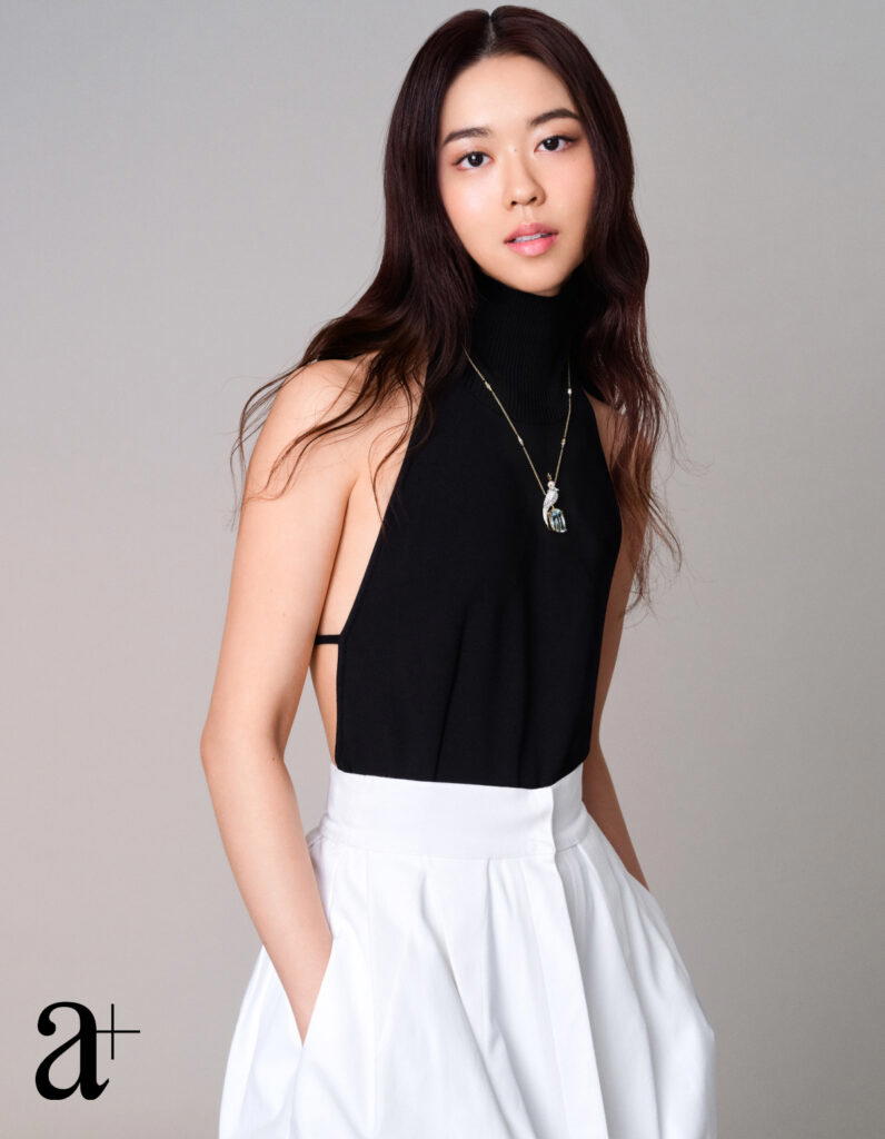 Jean Schlumberger by Tiffany & Co. Bird on a Rock Pendant in gold and platinum with an aquamarine, diamonds and sapphires, from Tiffany & Co. Viscose halter top and cotton skirt, both from Max Mara