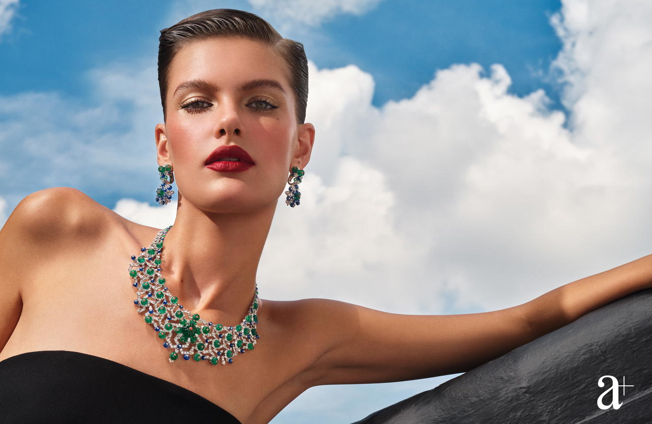 Echina High Jewellery necklace in white gold with emeralds, sapphires, coral, and diamonds, and Echina High Jewellery earrings in white gold with emeralds, sapphires, coral, and diamonds, all from Cartier. Wool bustier dress, from Max Mara