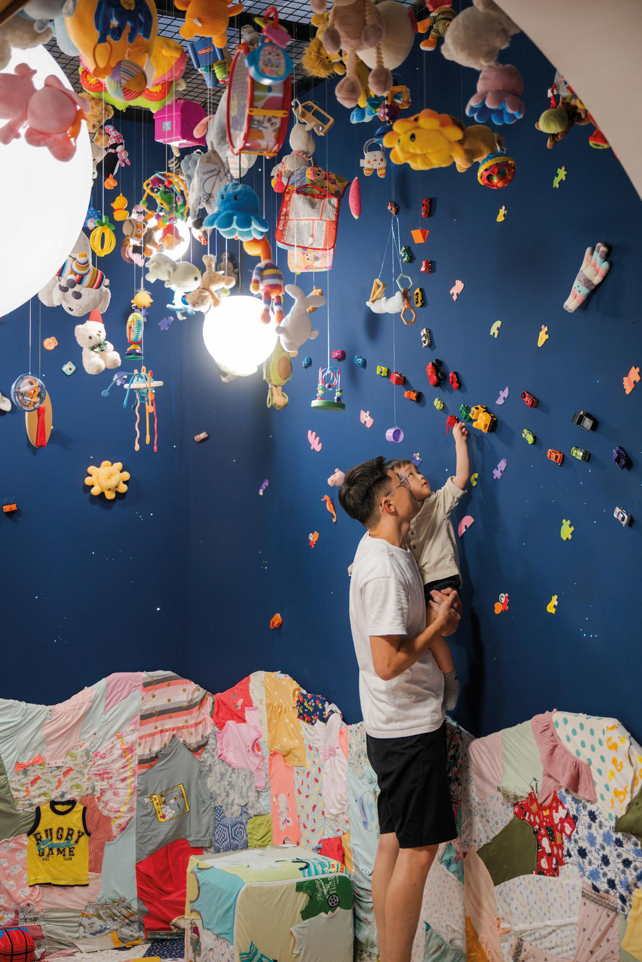 ‘Fantasy’ by Co2_karbondioksida features a whimsical mobile made from repurposed toys and donated children’s clothes. Photo: National Gallery Singapore