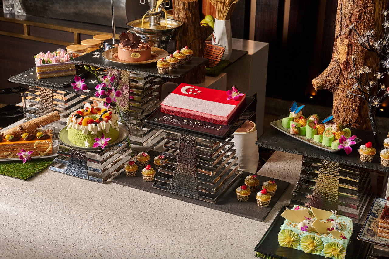 On 9 August, the festivities peak at Luce with a stunning display of 60 handcrafted cakes, featuring elegant takes on nostalgic treats like Ondeh Ondeh Swiss Roll and Milo Tiramisu Cake (Credit: Luce)