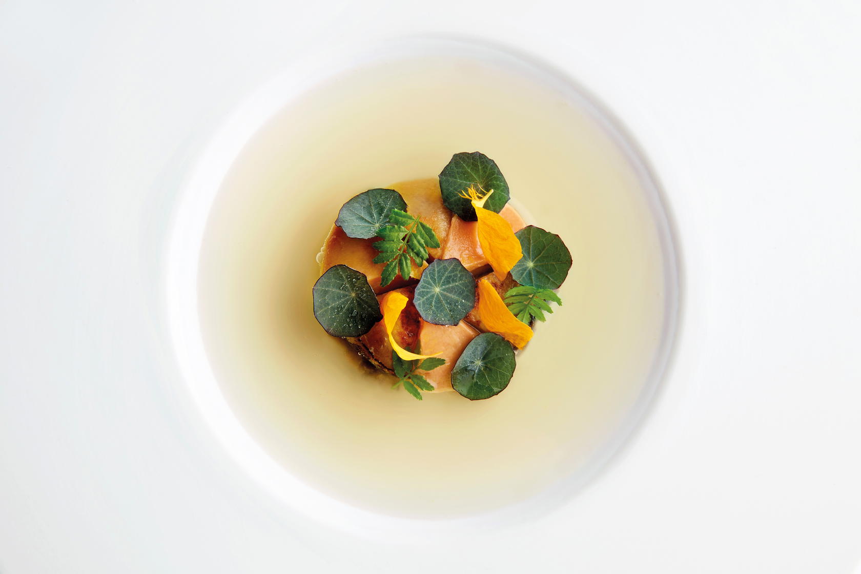 Royer’s Jeju Abalone & Foie Gras Duo is served with a yuzu-infused pork broth that’s inspired by bak kut teh (Credit: Odette)