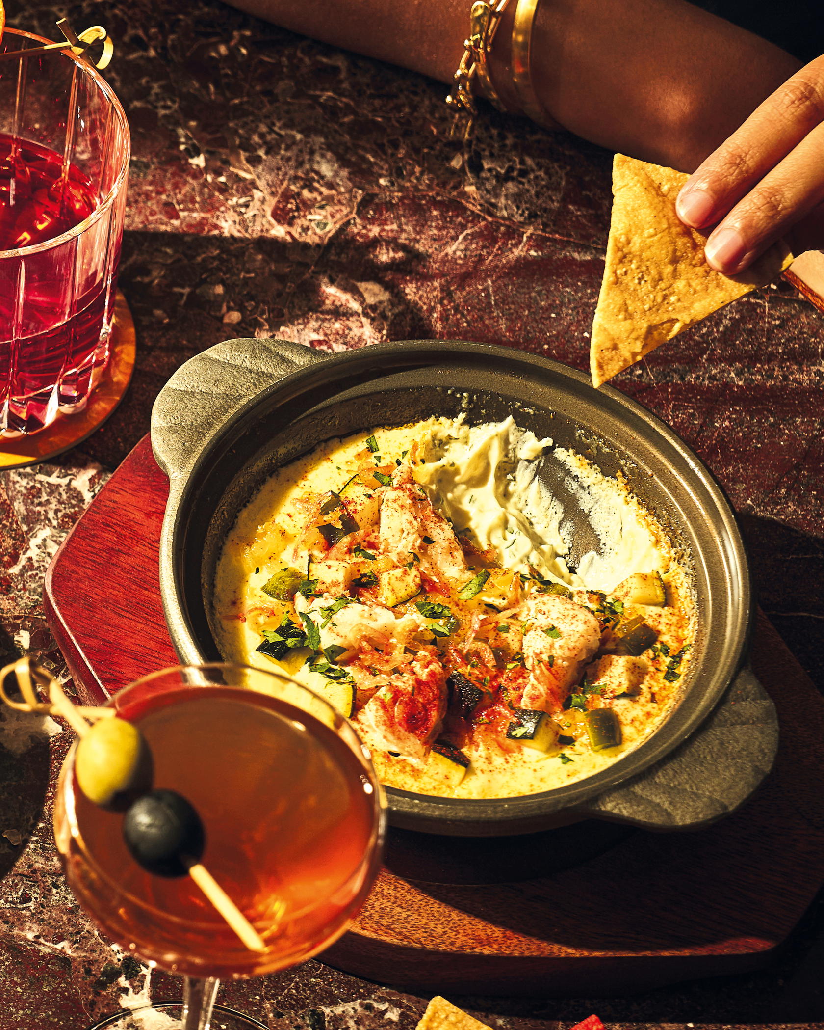 Warm Crab Queso with molten scarmoza, lump crab, Sakura ebi, and tortilla chips (Credit: Cudo)